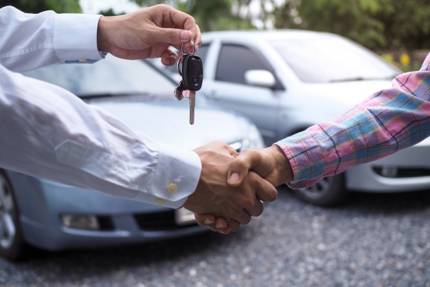 car keys exchanging hands